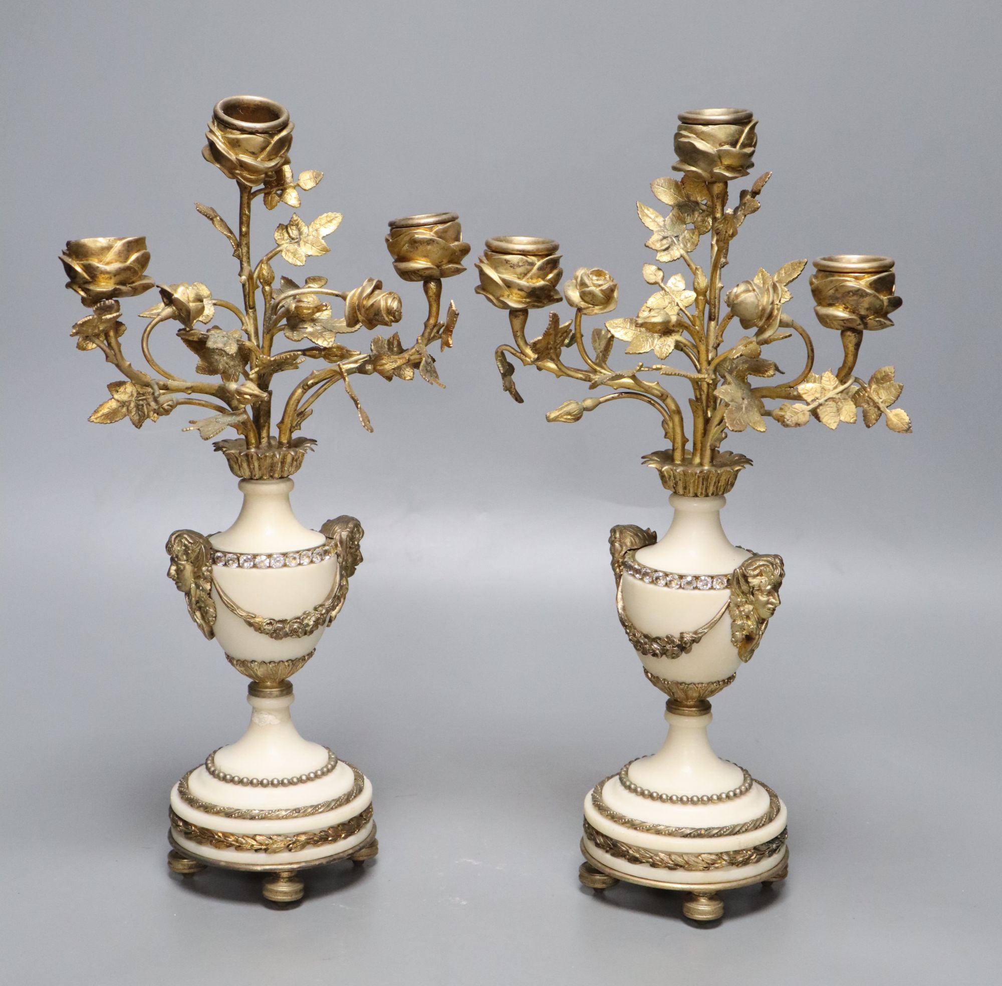A pair of gilt metal and alabaster three branch candelabra, height 31cm (one a.f.)